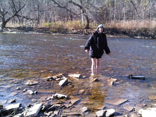 Photo of Jael taken in 2010 in Ontario during a focusing retreat. She was barefoot, the water was cold & she was in it for about 30 seconds. It was fun! The photo illustrates an adventure and new experience.